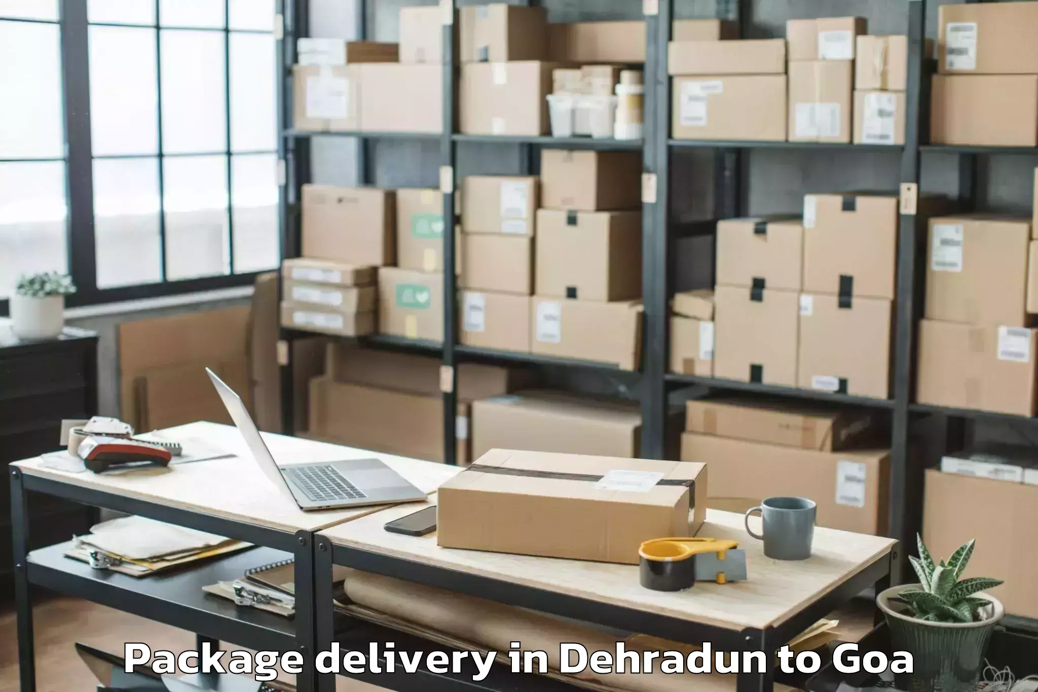 Affordable Dehradun to Mopa Package Delivery